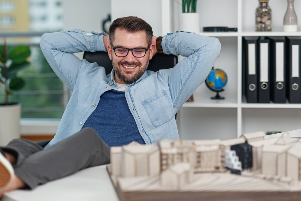 Man leaning back in a chair smiling at home diorama